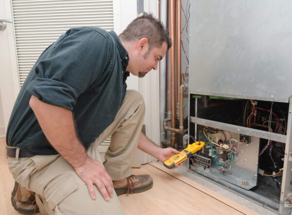 Tech checking air conditioner in Monroe Township, NJ.