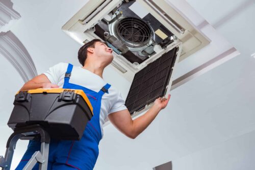 Tech repairing Air Conditioner unit in residential home in Monroe Township, NJ