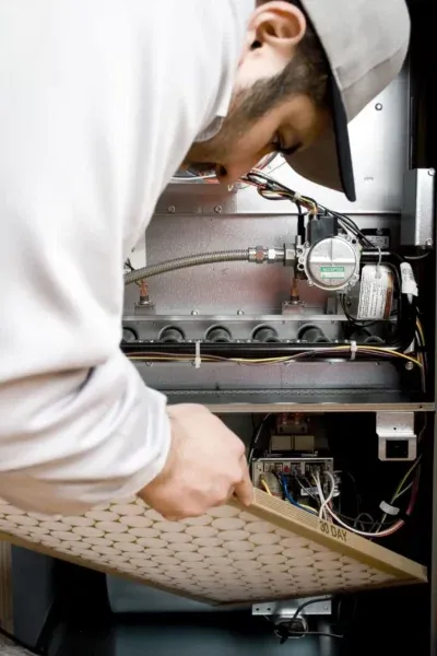Tech replacing furnace filter in Monroe Township, NJ