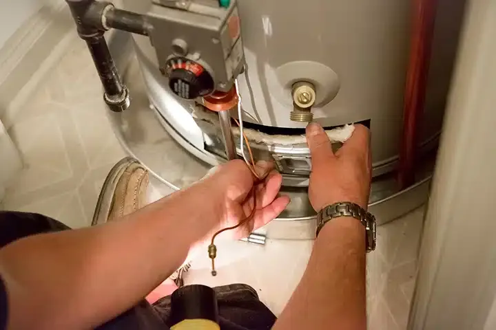 Tech checking water heater filter in Monroe Township, NJ.