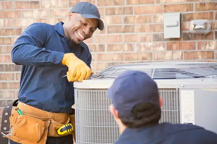 Techs repairing AC outside of residential home in Monroe Township, NJ.