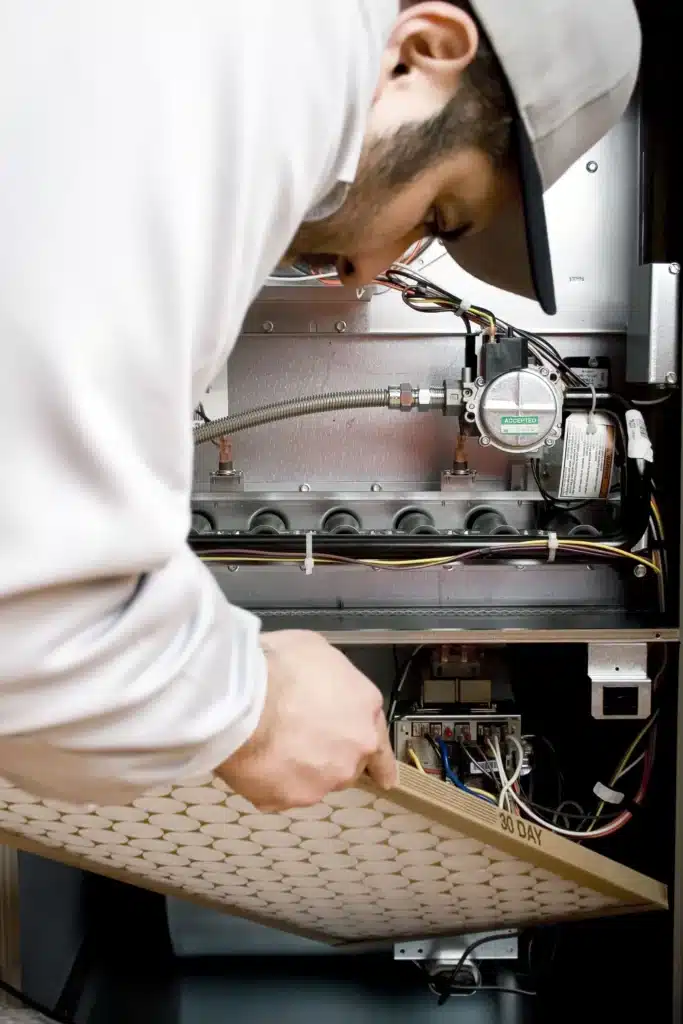 Tech replacing furnace filter in Monroe Township, NJ