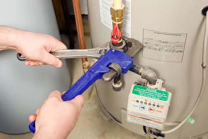 Tech adjusting water heater in Monroe Township, NJ.