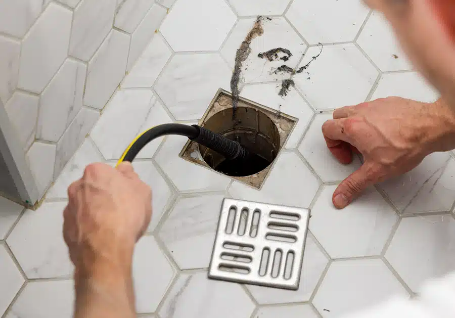 tech hydro jetting out hair from bathroom drain